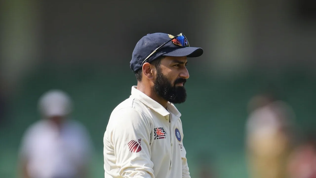 A fast bowler in India colours in his delivery stride during a Test match, with the batsman set at the other end