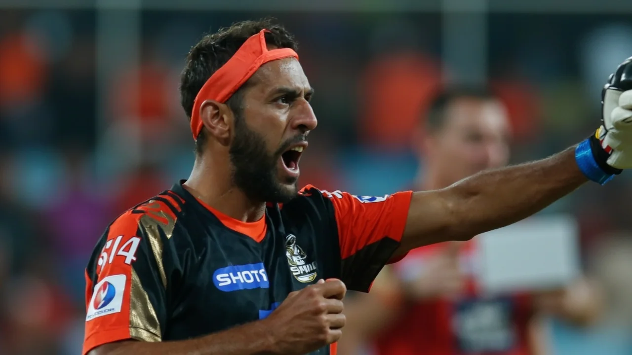 A captain batter driving through the leg side in a white IPL innings with the bowler following through in the foreground and the crowd lit by floodlights